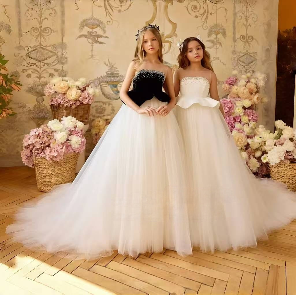 White and black flower girl dress with a beaded bodice and tulle skirt