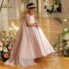 Dusty pink beaded flower girl dress with cap sleeves and handmade flowers