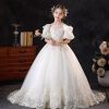 Off-white flower girl dress with lace appliques and a bow