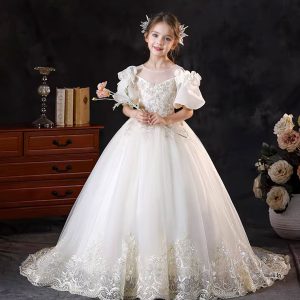 Off-white flower girl dress with lace appliques and a bow