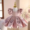 Pink appliqued flower girl dress for a toddler birthday party