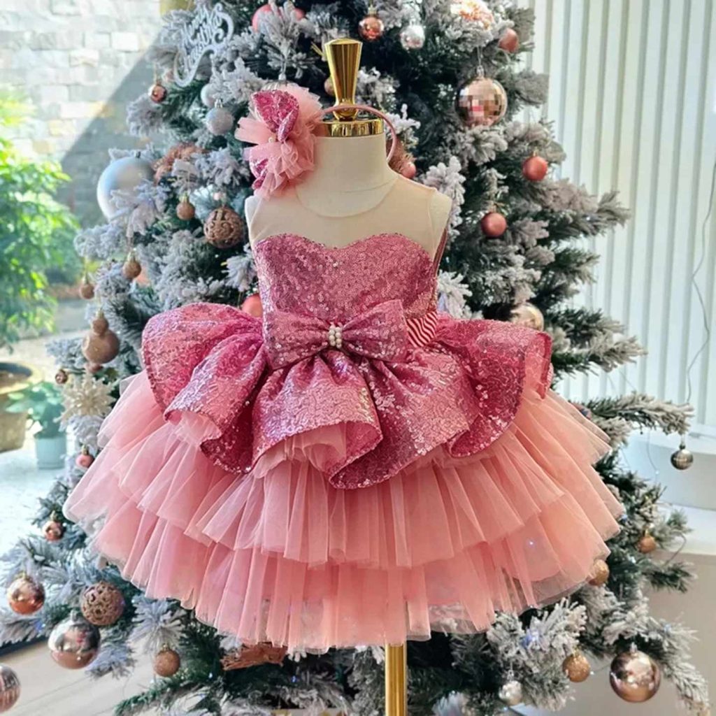 Pink sequinned bow flower girl dress with a tiered tulle skirt
